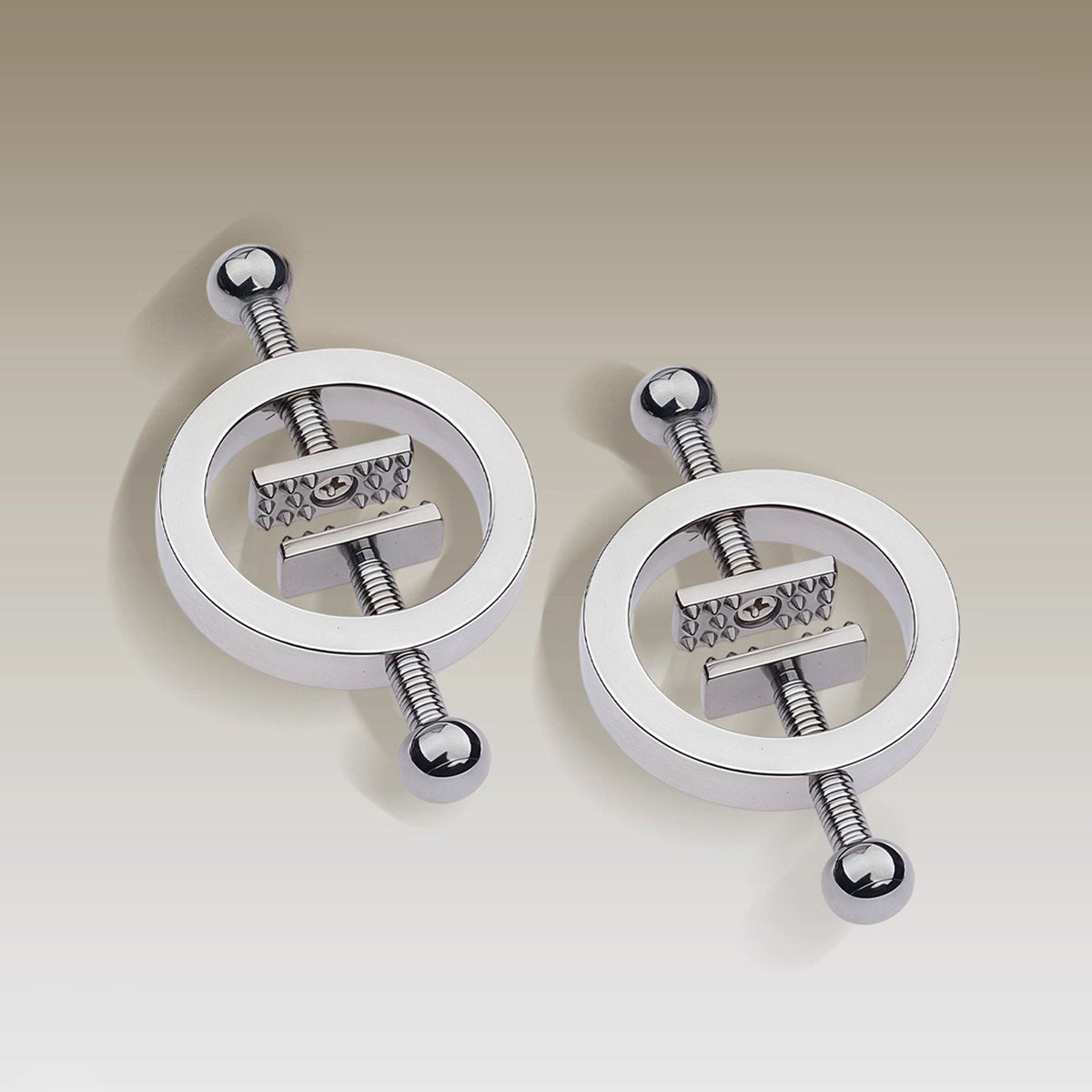 Close-up of heavy-duty screw-plate metal nipple clamps with adjustable pressure mechanism for professional BDSM play by Sexy Maker.
