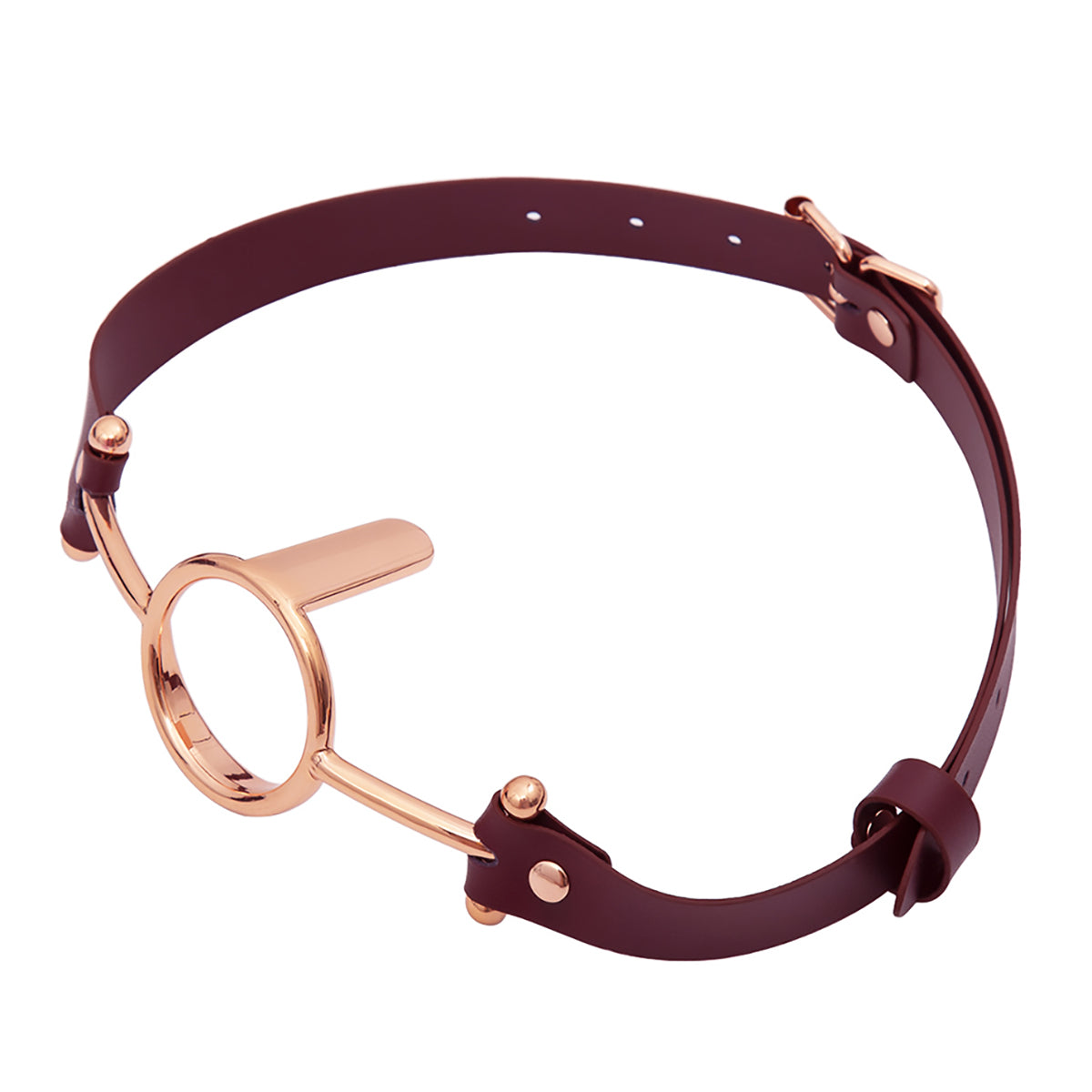 Close-up of luxurious gold metal O-ring tongue depressor gag with black premium vegan leather straps for oral bondage and deepthroat training by Sexy Maker.