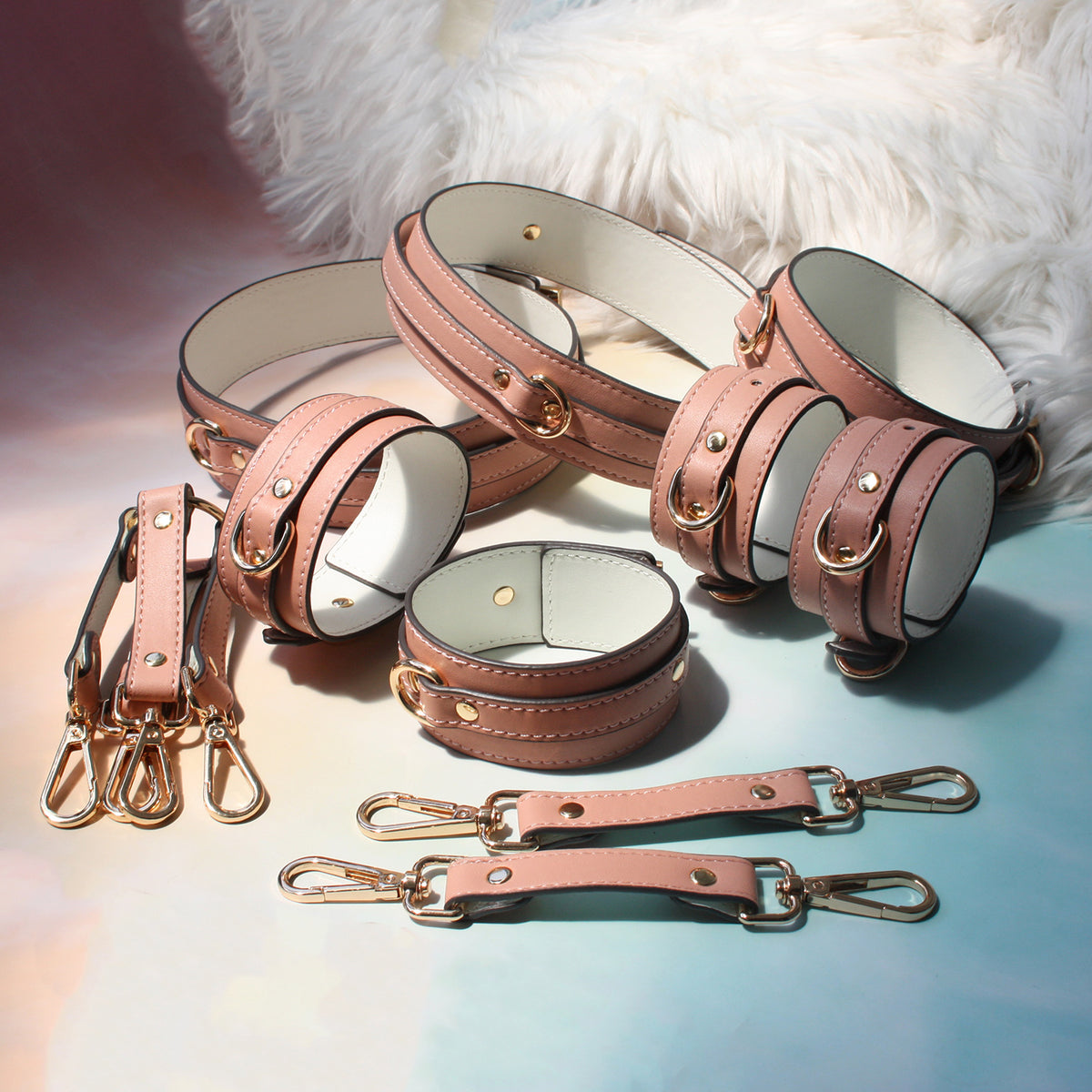 Complete pink bondage kit laid flat – collar leash wrist ankle thigh cuffs hogtie connector