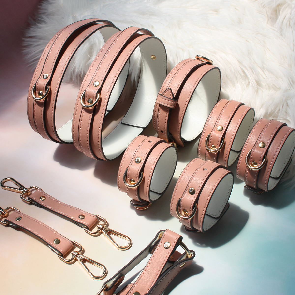 Complete pink bondage kit laid flat – collar leash wrist ankle thigh cuffs hogtie connector