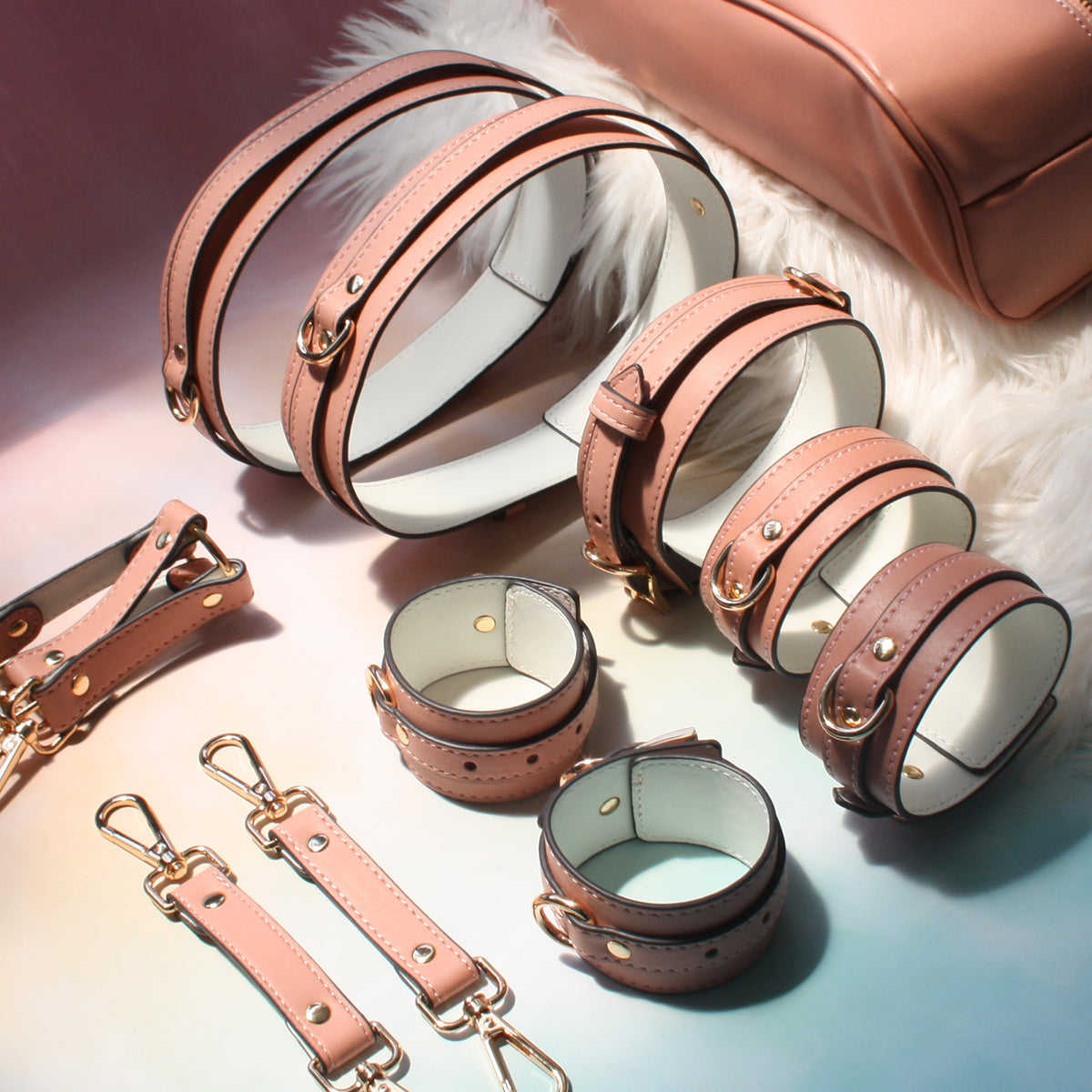 Complete pink bondage kit laid flat – collar leash wrist ankle thigh cuffs hogtie connector