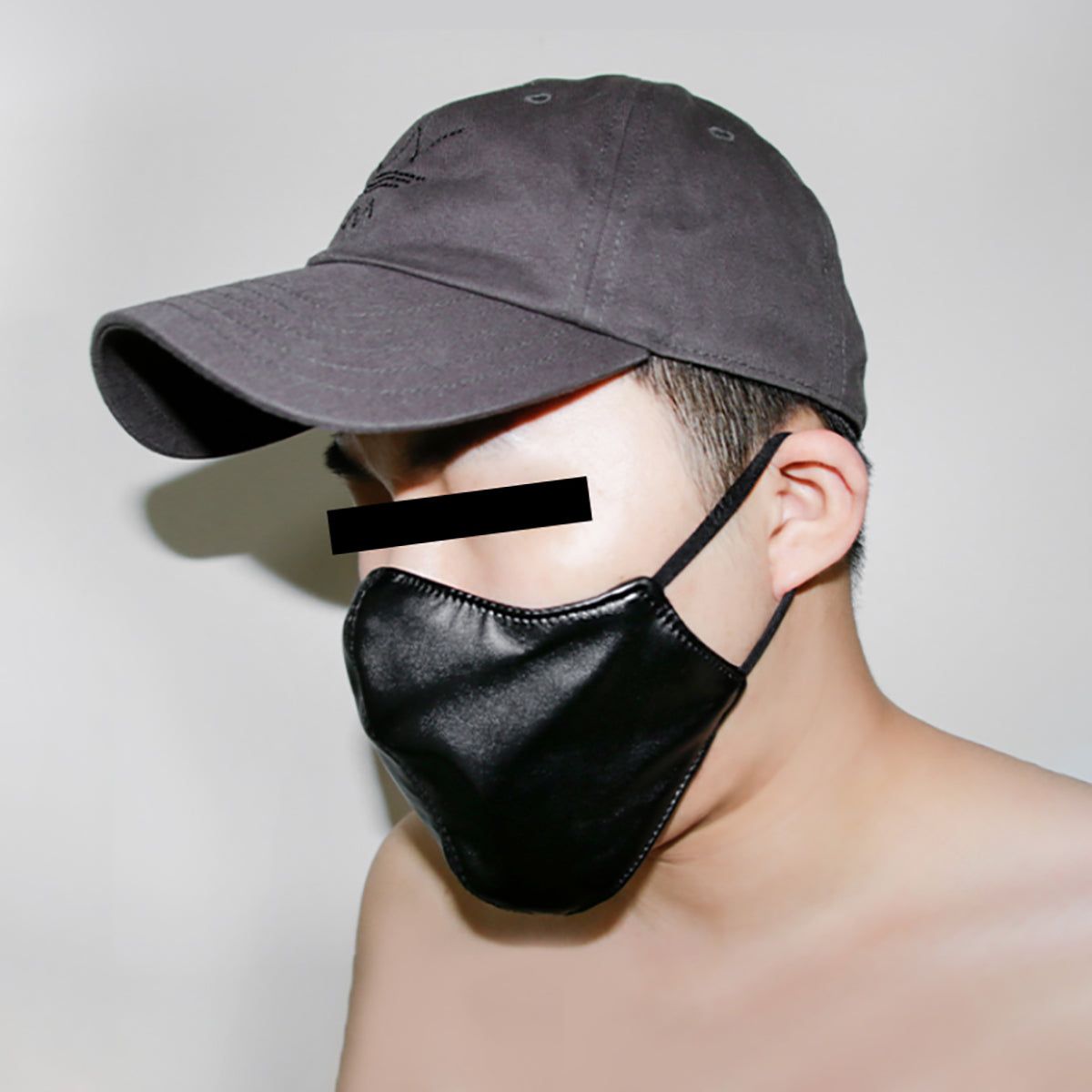Black vegan leather fashion face mask with a hidden built-in silicone dildo gag for discreet public BDSM play by Sexy Maker.
