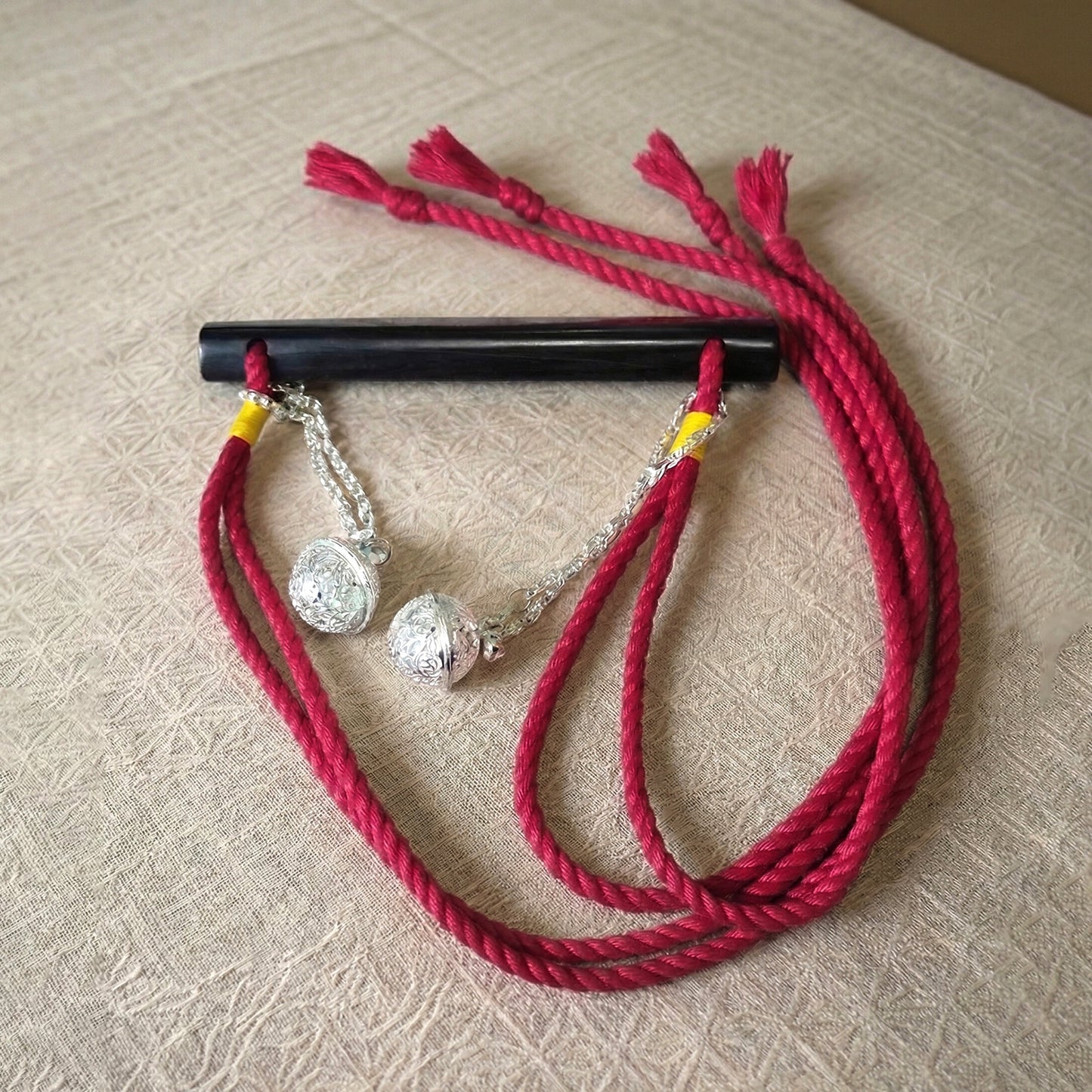 Authentic Japanese BDSM wood gag with crimson red jute rope and sensory bells for Shibari and Kinbaku roleplay by Sexy Maker.