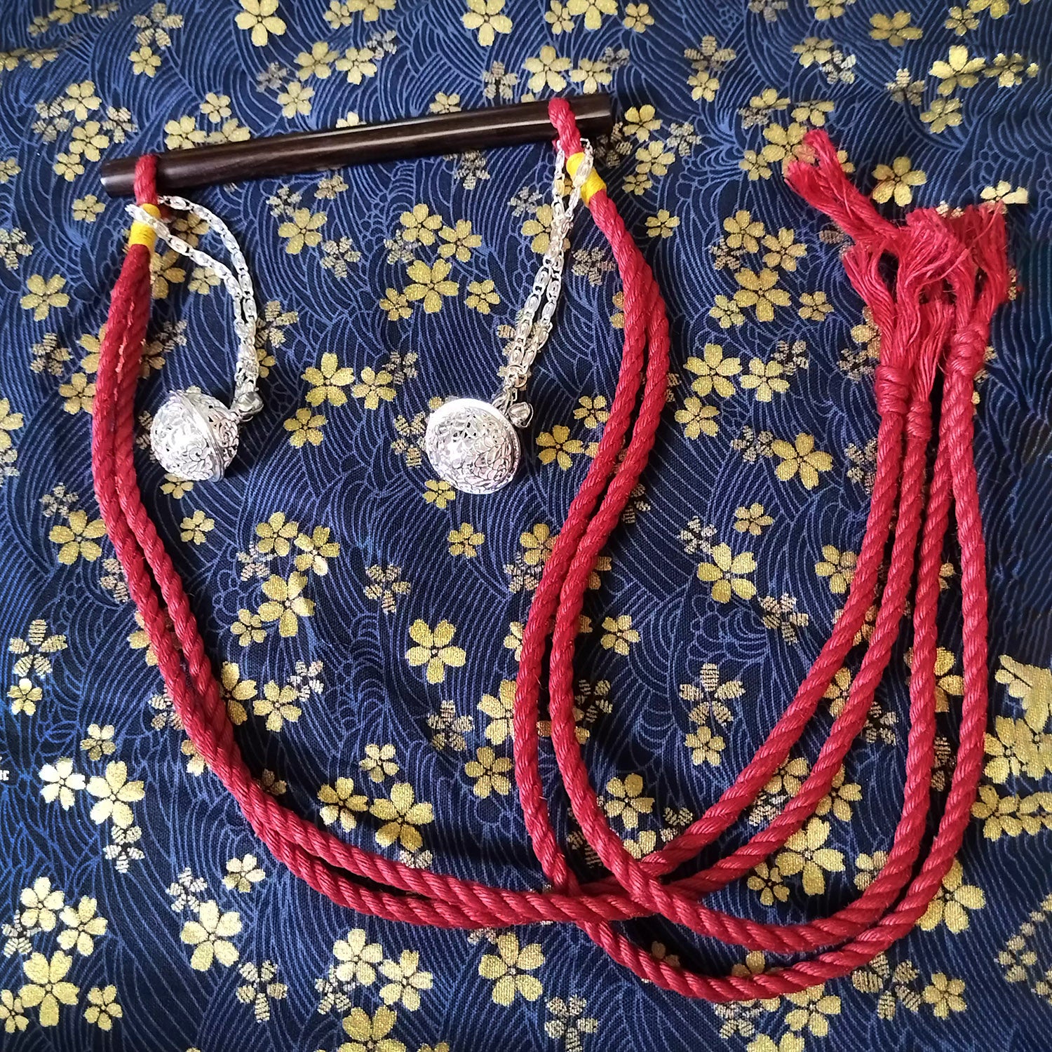 Authentic Japanese BDSM wood gag with crimson red jute rope and sensory bells for Shibari and Kinbaku roleplay by Sexy Maker.