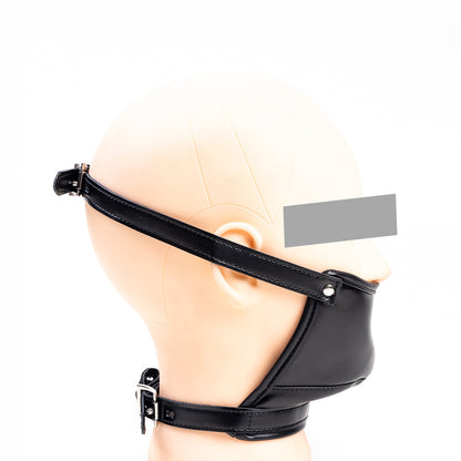 Front view of black vegan leather concealed dildo gag mask with adjustable head and neck straps for oral restraint by Sexy Maker.