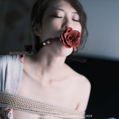 Close-up of breathable red silicone rose ball gag with adjustable vegan leather straps for aesthetic BDSM play by Sexy Maker.
