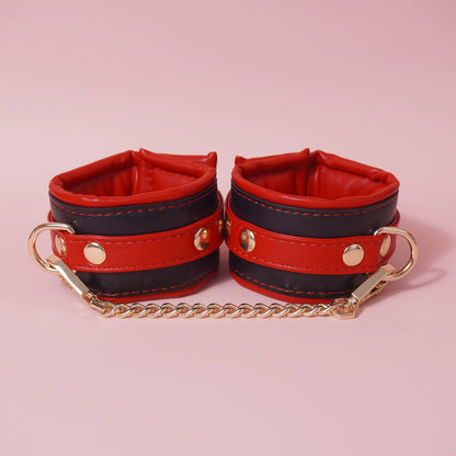 Close-up of the complete 7-piece premium vegan leather bondage starter set featuring padded cuffs, collar, and paw print paddle by Sexy Maker.