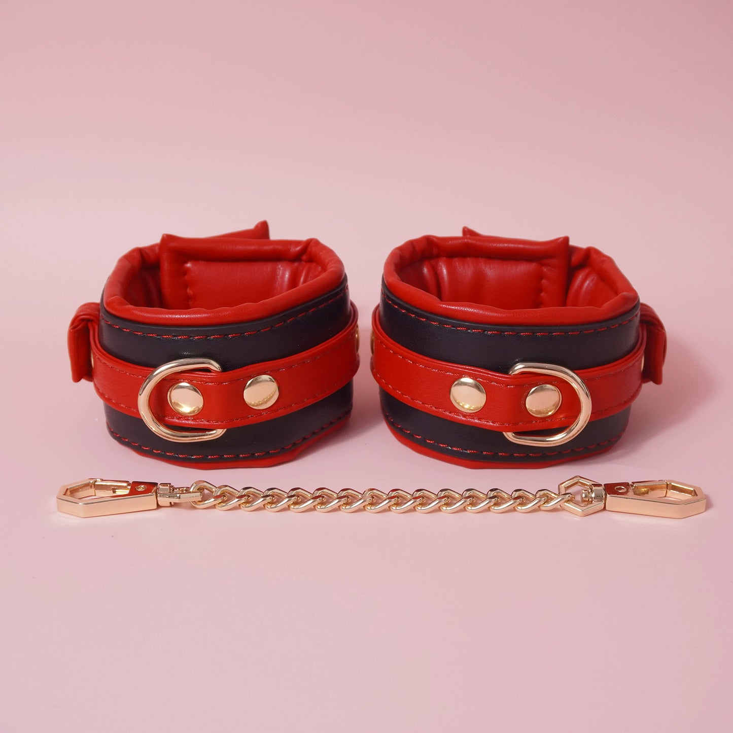 Close-up of the complete 7-piece premium vegan leather bondage starter set featuring padded cuffs, collar, and paw print paddle by Sexy Maker.