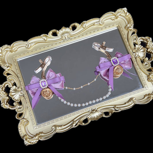 Close-up of adjustable purple ribbon nipple clamps with connecting chain and sparkling stones, beginner-friendly romantic BDSM jewelry by Sexy Maker.