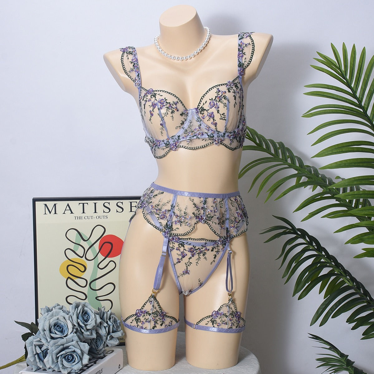 Front view of women's 3-piece lavender floral embroidery lace lingerie set featuring sheer mesh push-up bra and garter belt by Sexy Maker.
