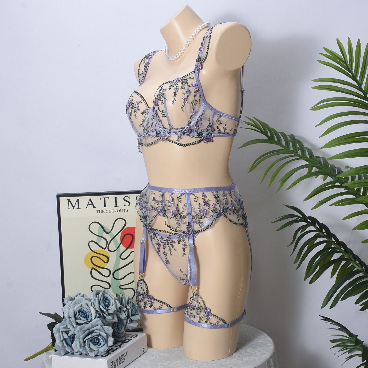 Front view of women's 3-piece lavender floral embroidery lace lingerie set featuring sheer mesh push-up bra and garter belt by Sexy Maker.
