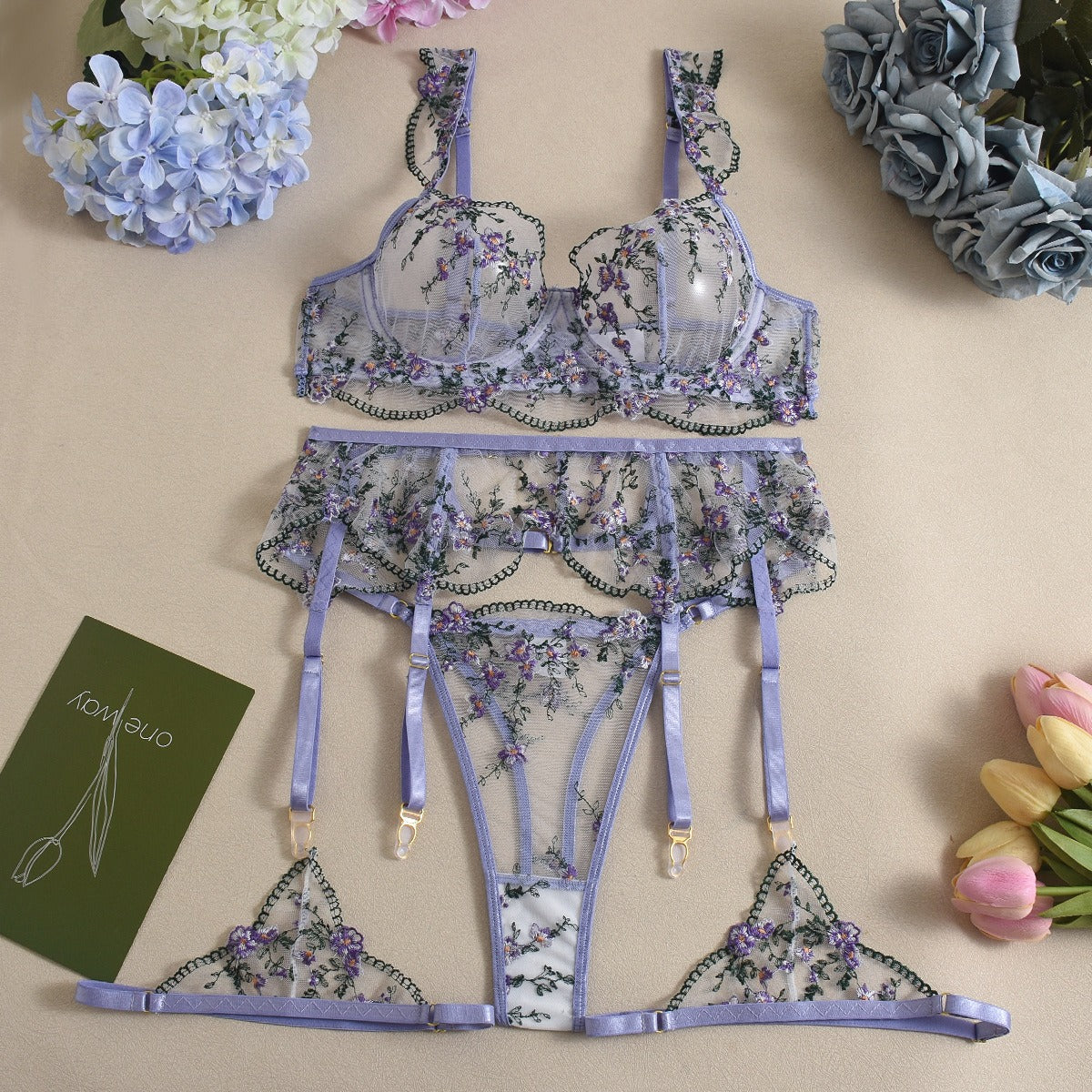 Front view of women's 3-piece lavender floral embroidery lace lingerie set featuring sheer mesh push-up bra and garter belt by Sexy Maker.