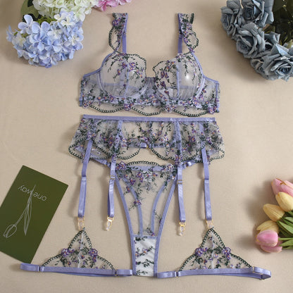 Front view of women's 3-piece lavender floral embroidery lace lingerie set featuring sheer mesh push-up bra and garter belt by Sexy Maker.