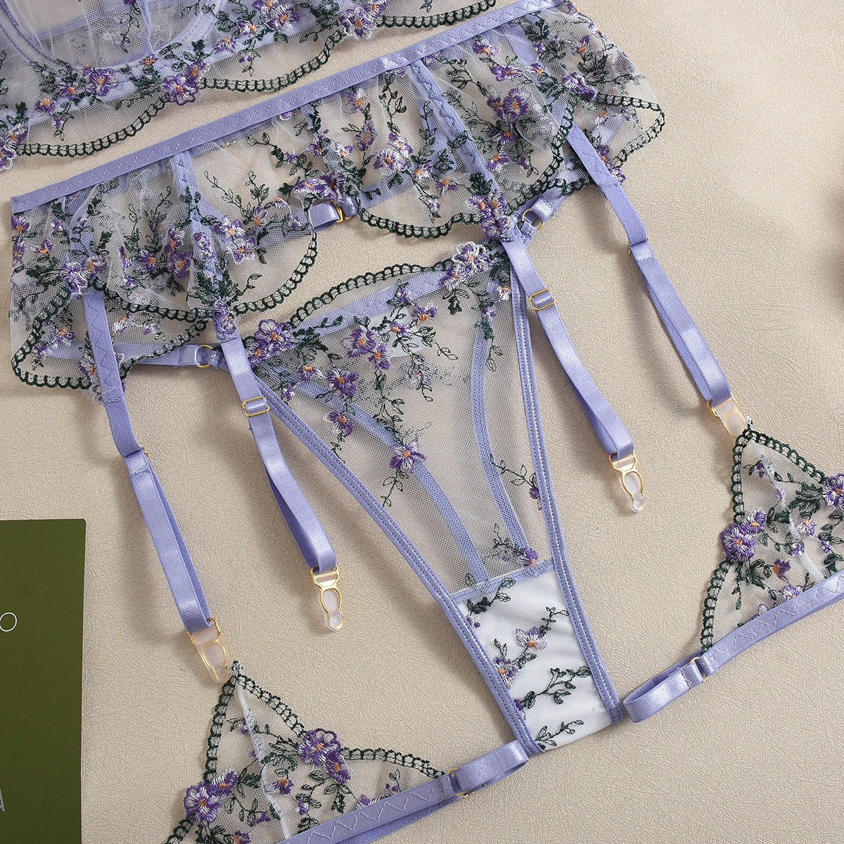 Front view of women's 3-piece lavender floral embroidery lace lingerie set featuring sheer mesh push-up bra and garter belt by Sexy Maker.