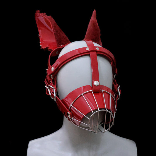 Close-up of glossy wet-look red human pup metal cage muzzle mask featuring feral fluffy faux fur ears and silver hardware for intense pet play by Sexy Maker.